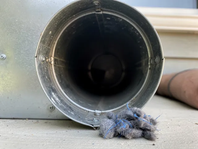 West Palm Beach Dryer Vent Cleaning technician using specialized equipment to clear severe dryer vent blockage in West Palm Beach